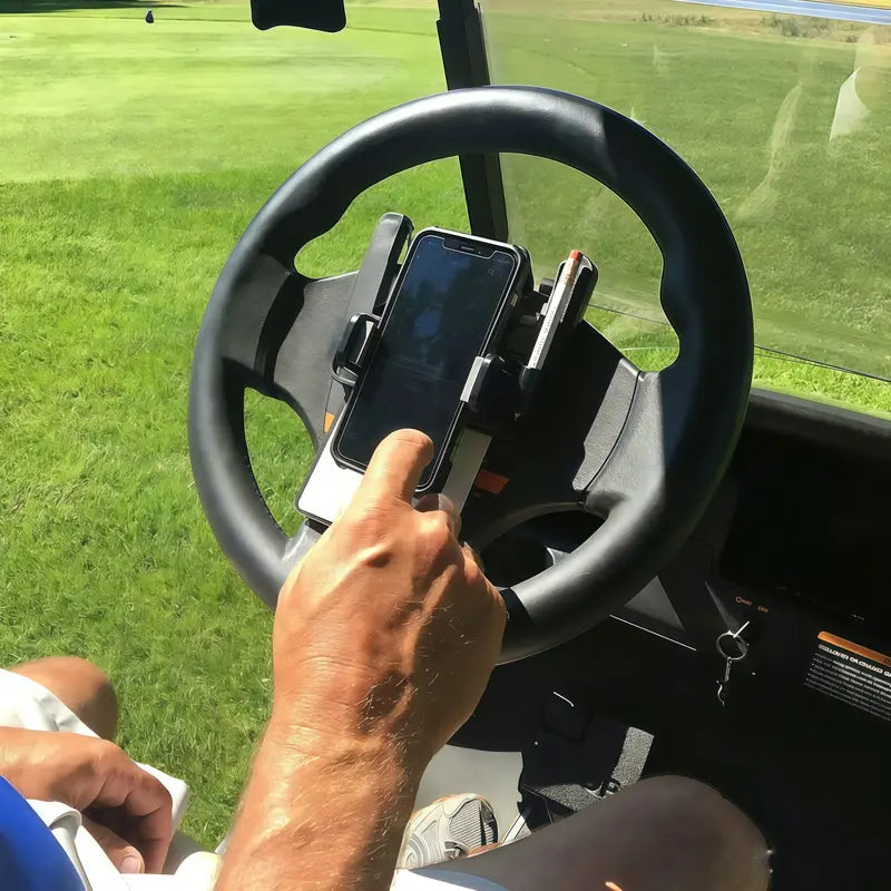 Golfer placing a smartphone into the golf cart steering wheel phone holder